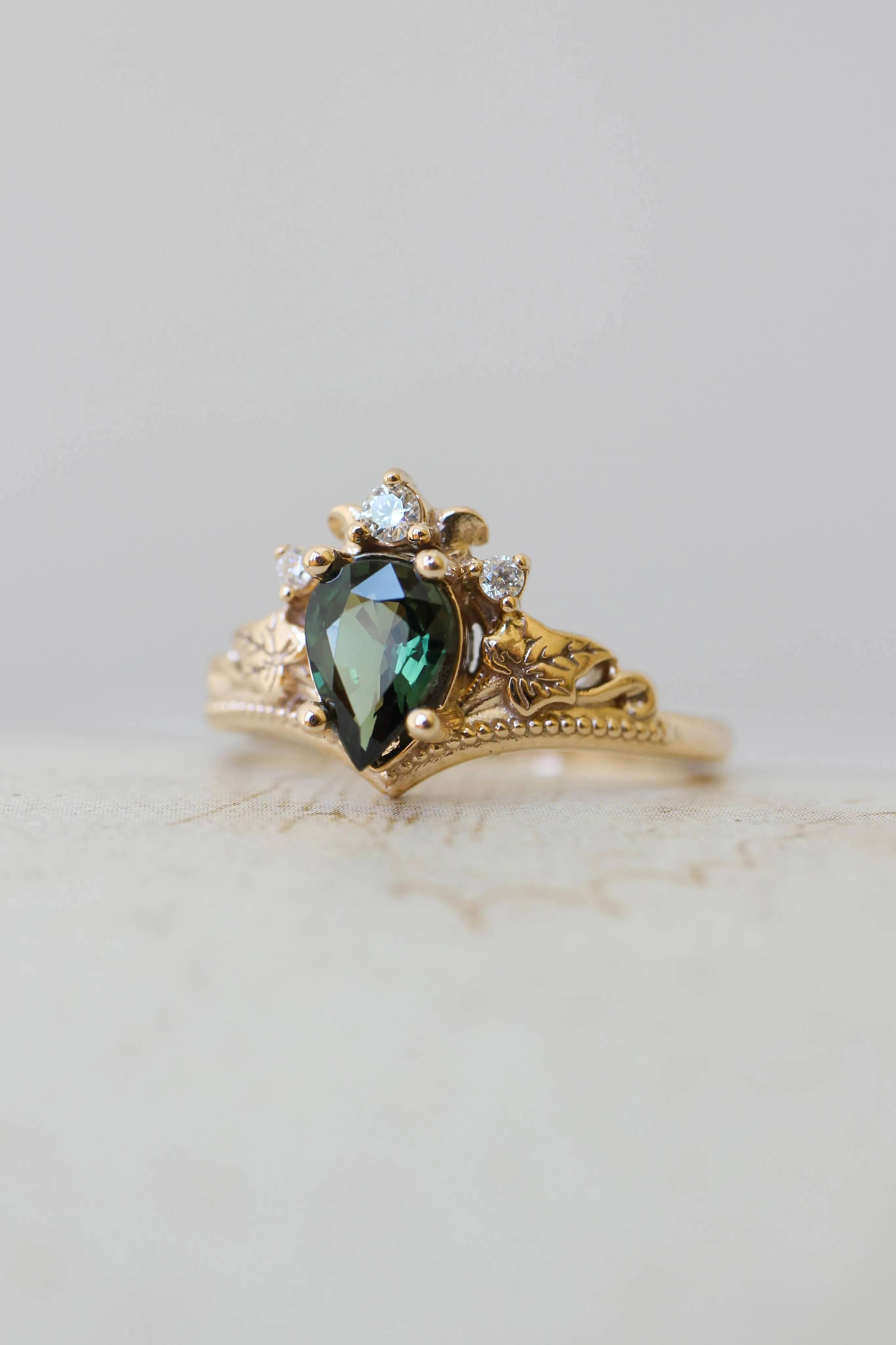 Custom request: Ariadne engagement ring with pear cut emerald and diamonds