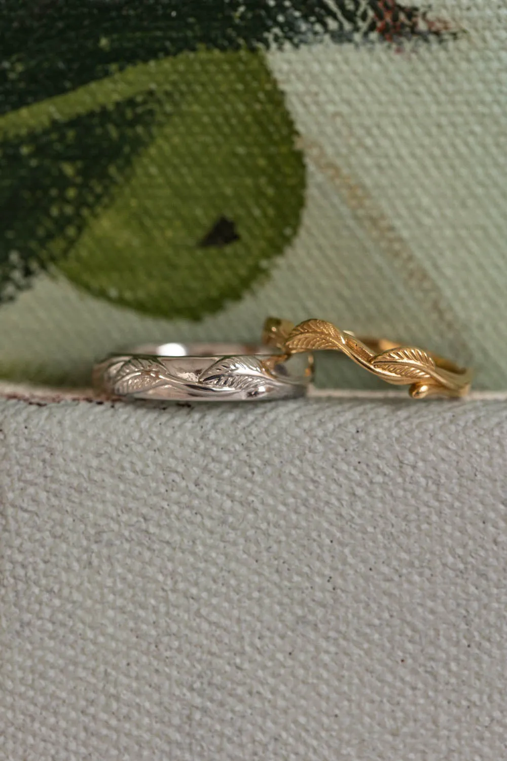 Wedding rings set for couples: white gold leaf band for him, gold twig band for her