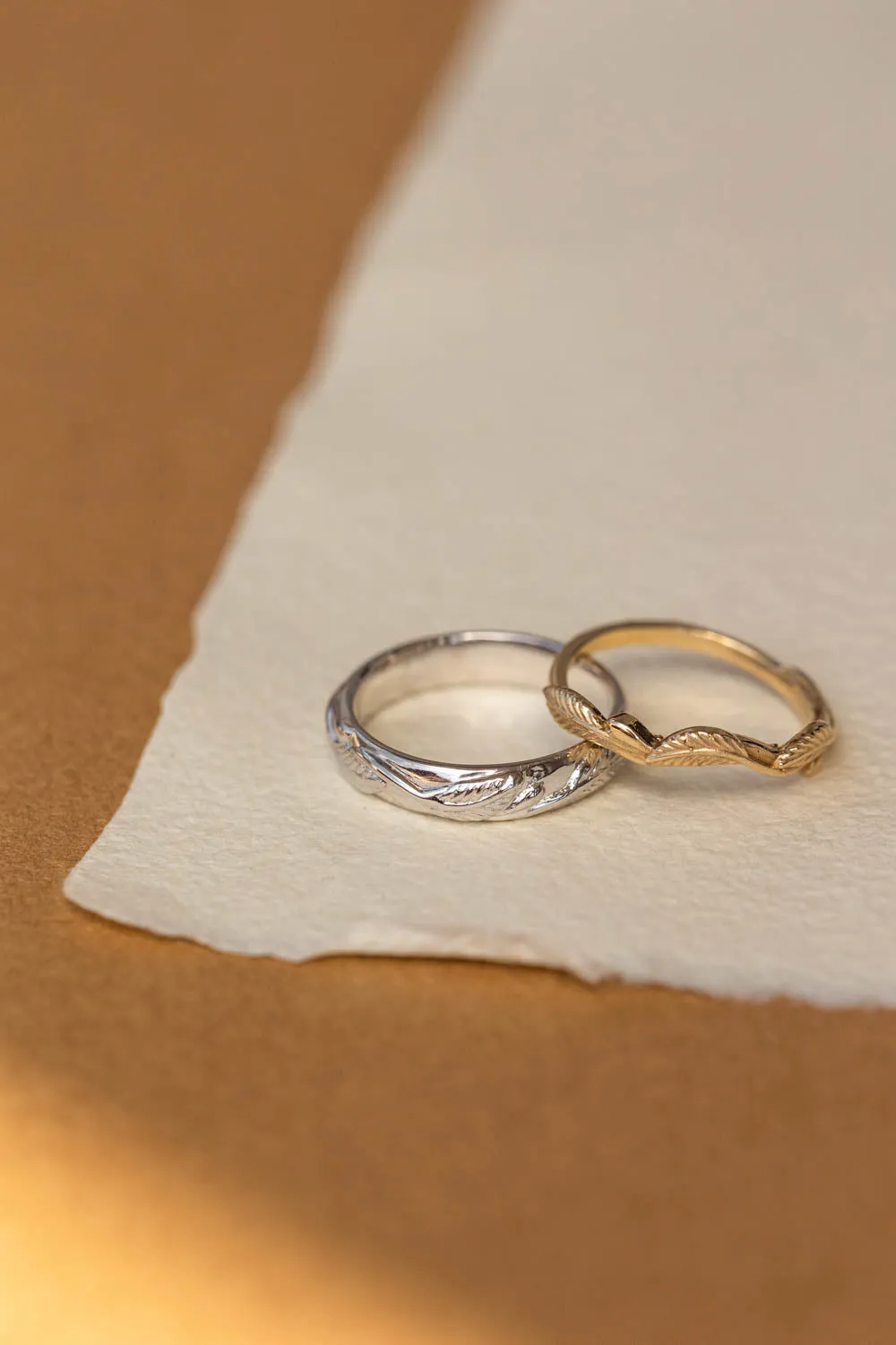 Wedding rings set for couples: white gold leaf band for him, gold twig band for her