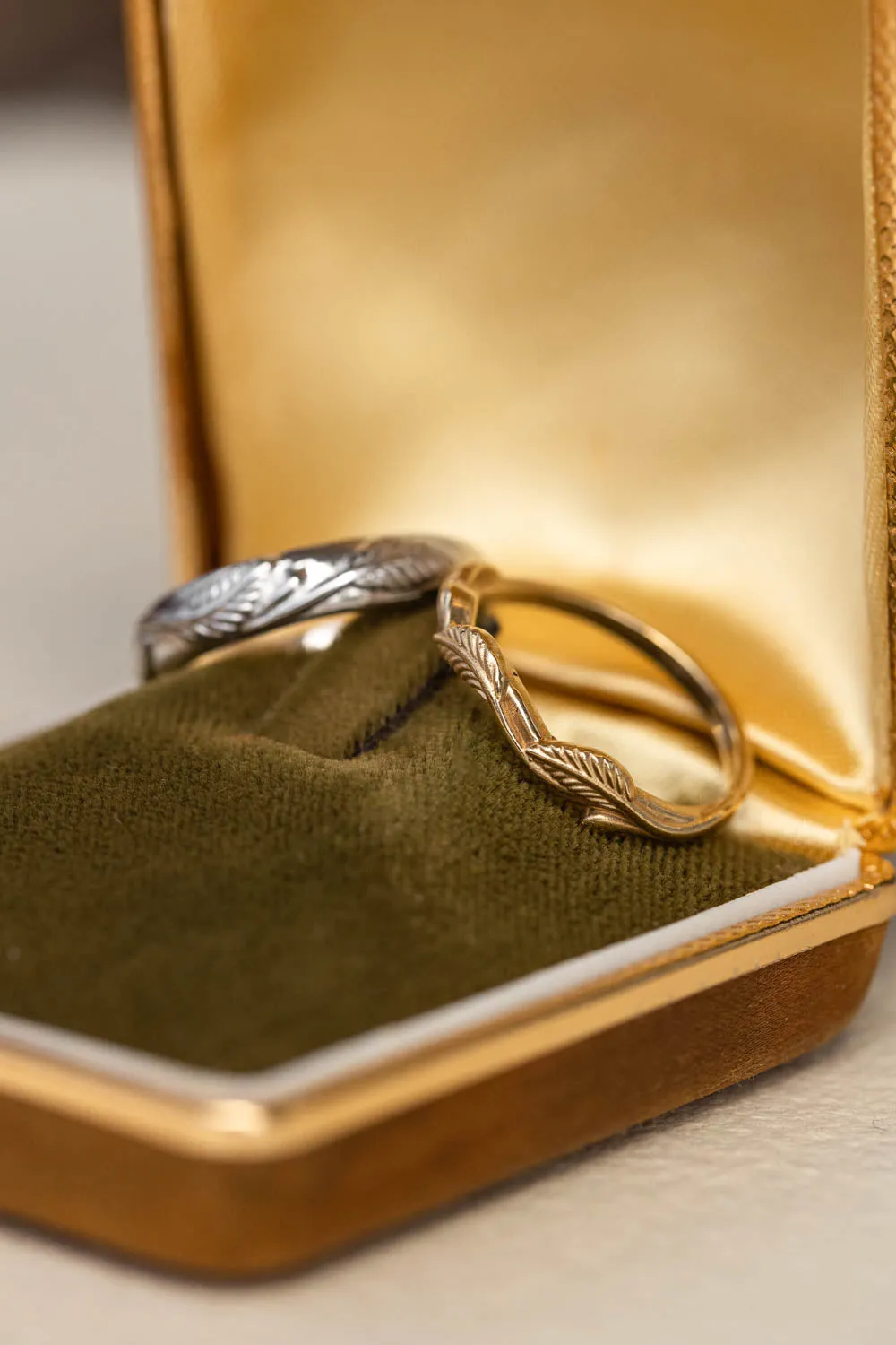 Wedding rings set for couples: white gold leaf band for him, gold twig band for her